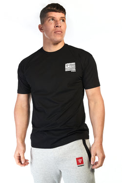 Man wearing unisex black cotton tshirt with small white flag style logo on the chest and big flag logo on the back