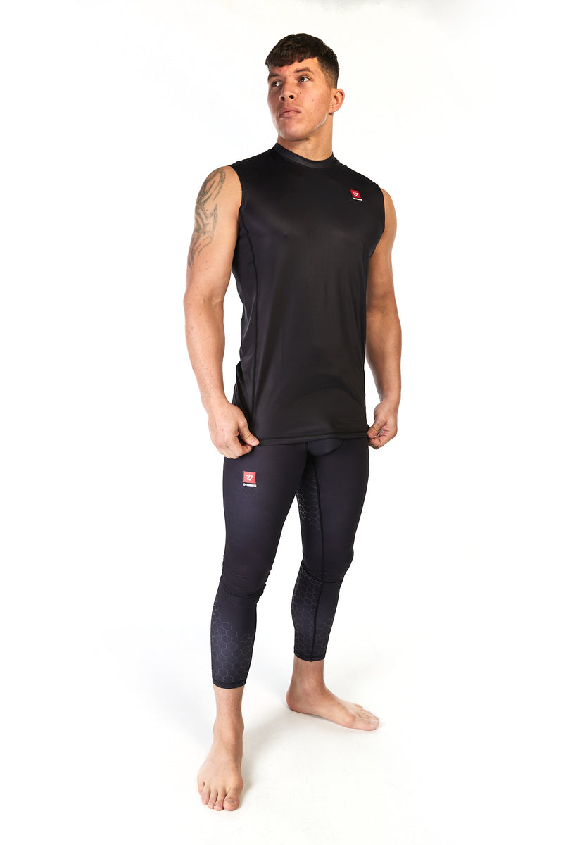 Man wearing compression fit leggings (spats) in black with a small red logo on the right leg
