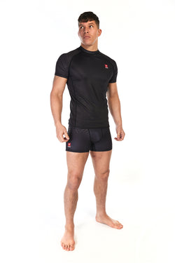 Man wearing unisex short sleeve training top in black with small red Gambaru Fightwear logo on the chest