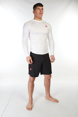 Man wearing unisex long sleeve training top in white with small red Gambaru Fightwear logo on the chest