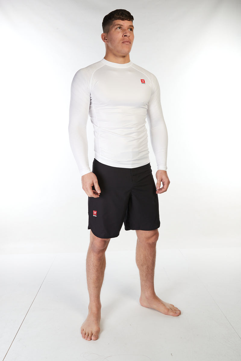 Man wearing unisex long sleeve training top in white with small red Gambaru Fightwear logo on the chest