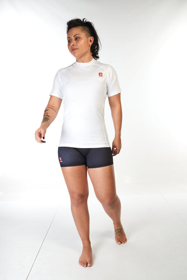 Woman wearing unisex short sleeve training top in white with small red Gambaru Fightwear logo on the chest